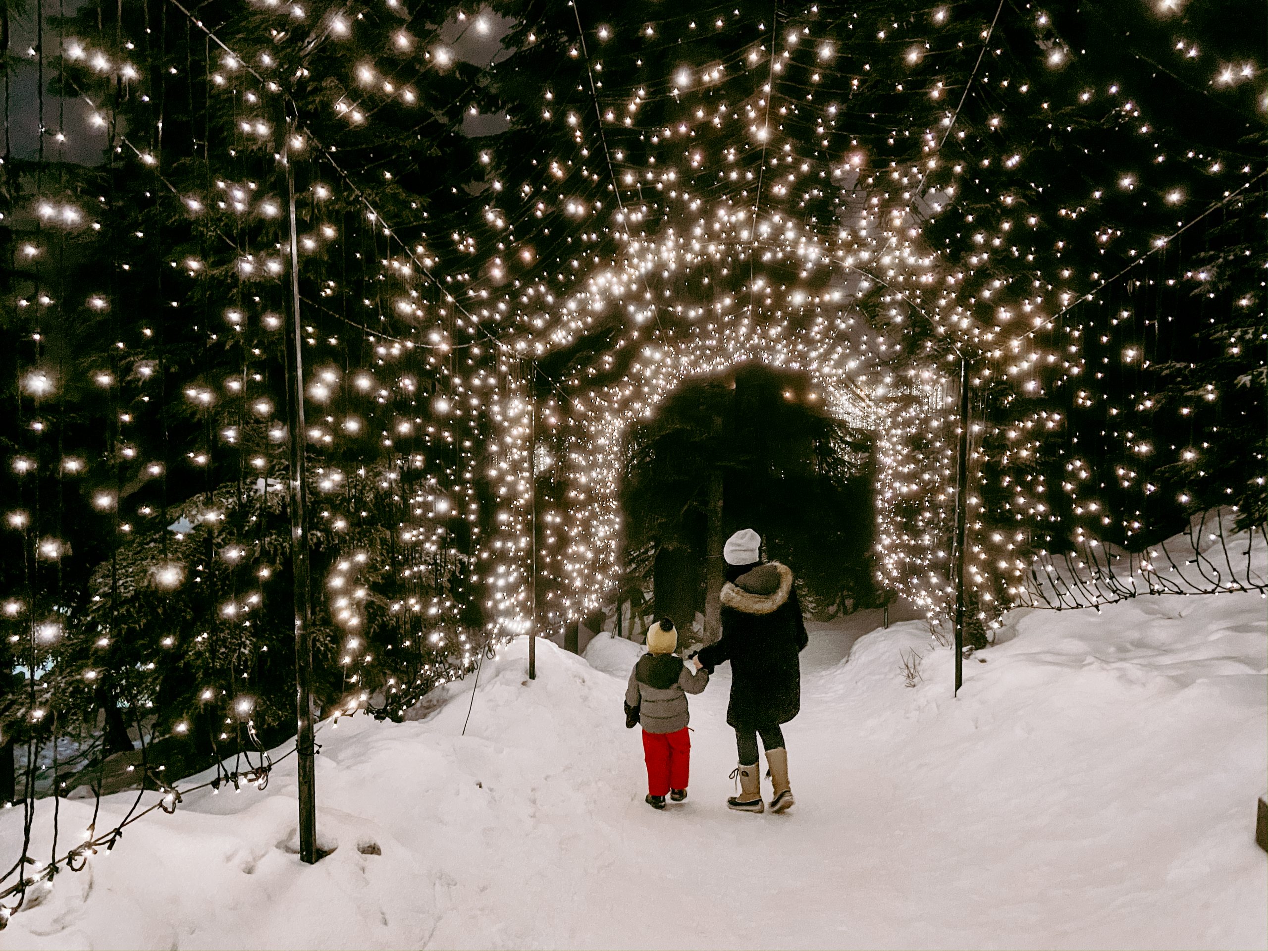 Woman and child walking through light walk